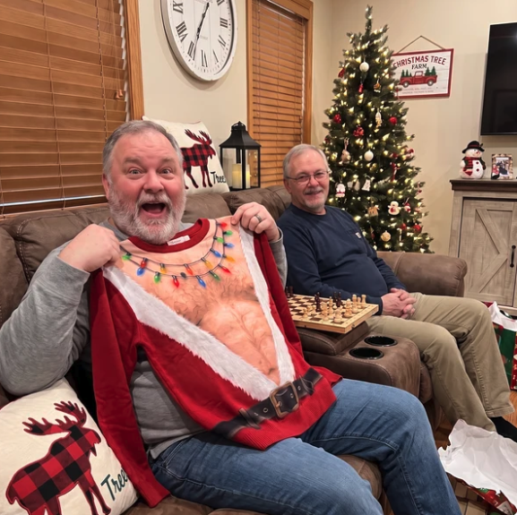 Laughing while holding the sweater
